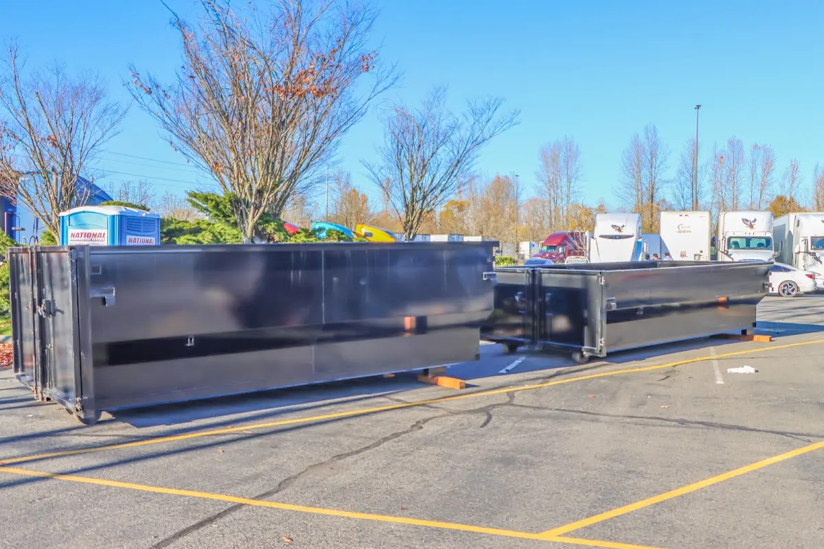 Professional dumpster rental service with roll-off container on residential driveway in Palm Springs